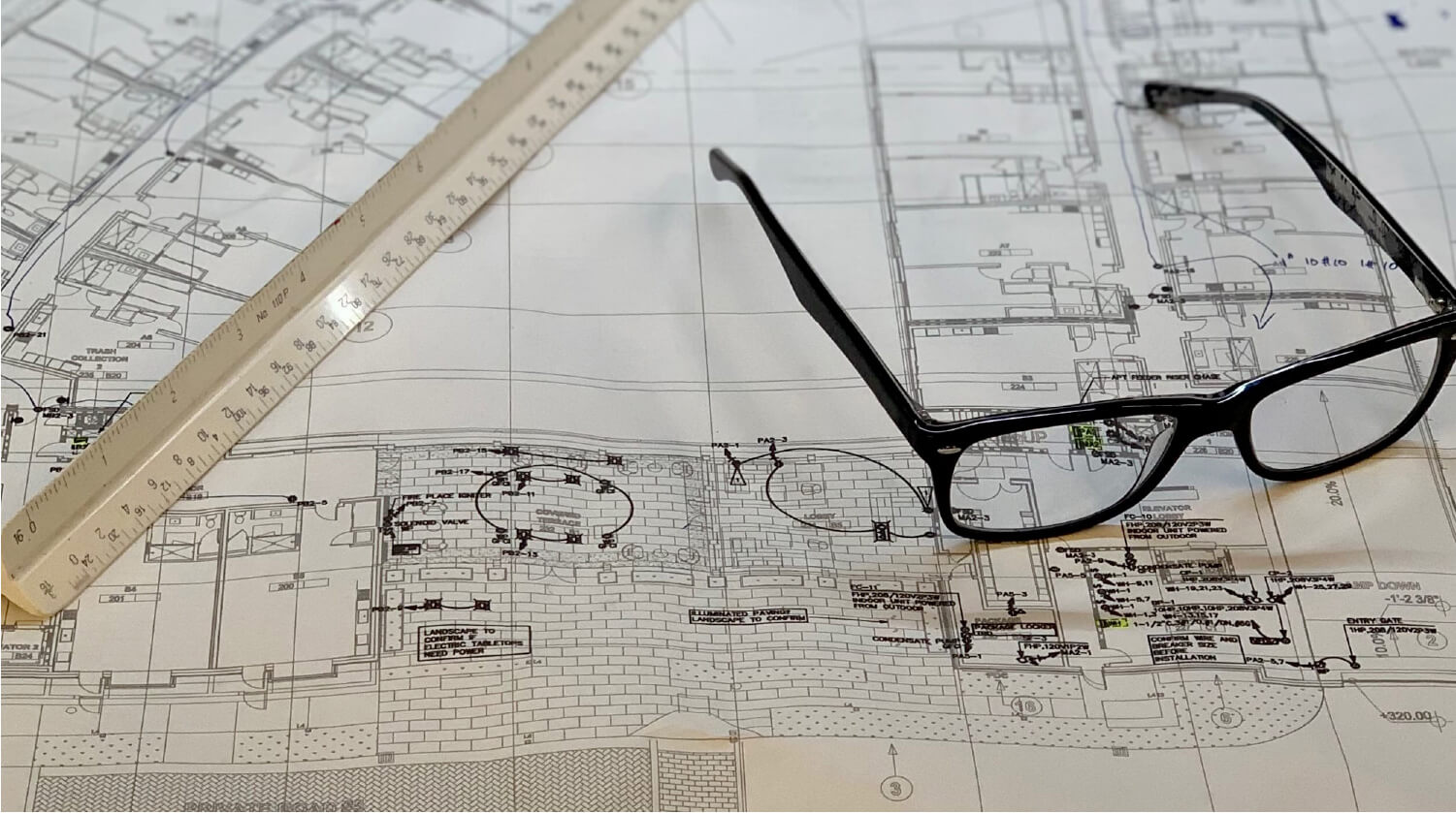 glasses on top of blueprints